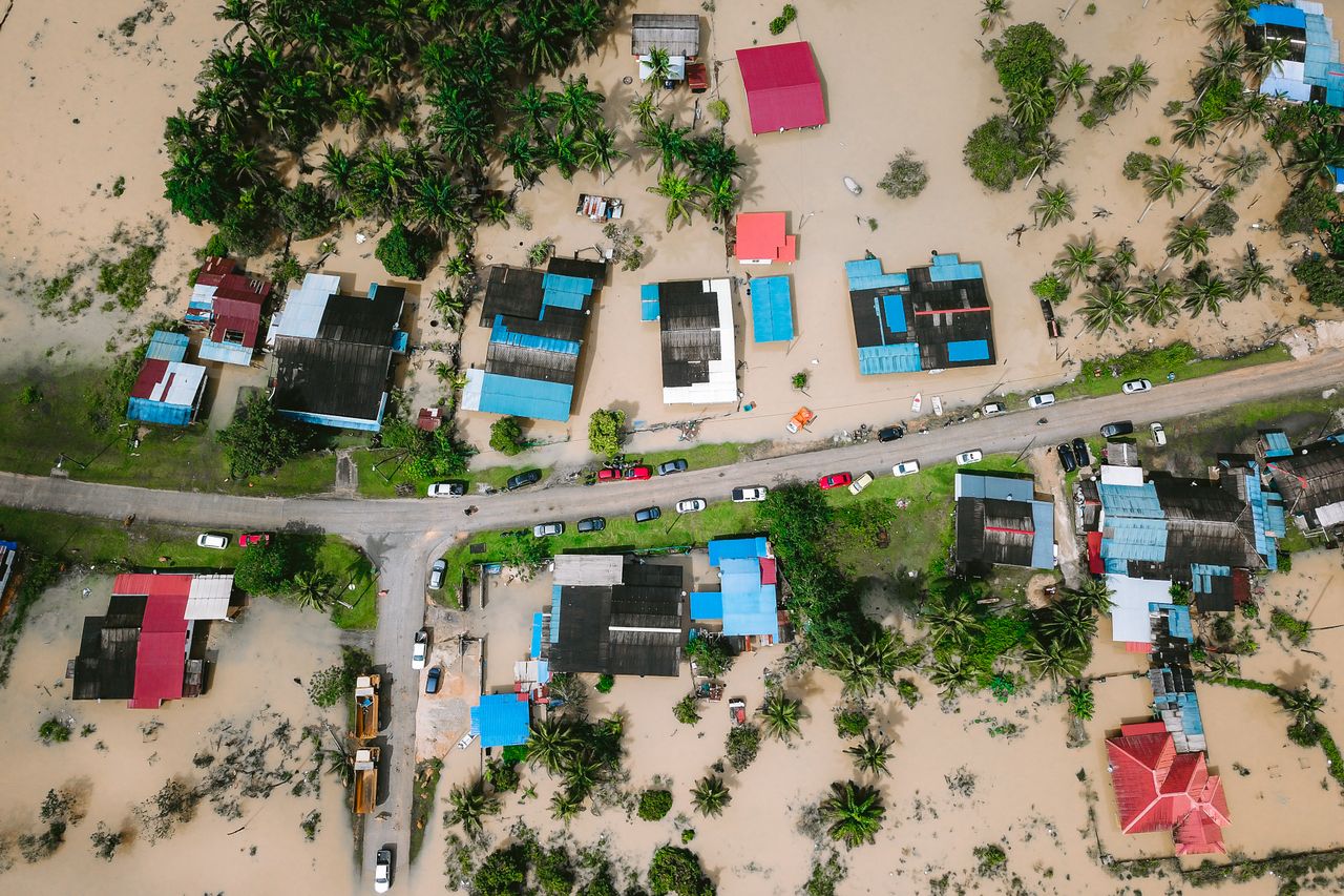 hero-img-02 Aerial shot showing flooded houses in Kijal, Terengganu, Malaysia, highlighting the impact of natural disasters.