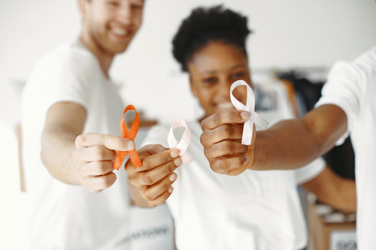 services-03 Diverse group holding health awareness ribbons, showing unity and support.