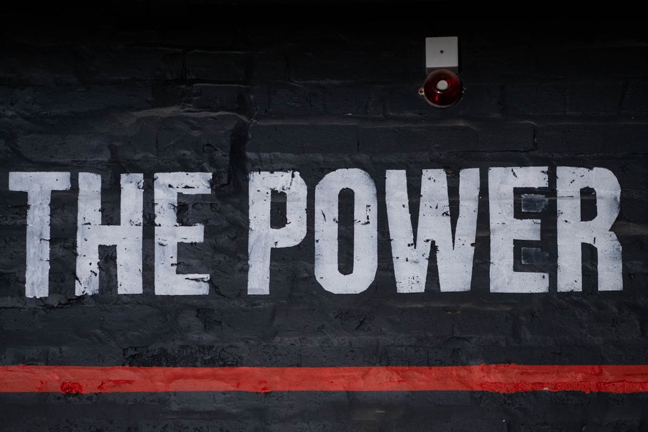 why-choose-us Close-up of 'The Power' graffiti on a dark wall, emphasizing strength and impact.